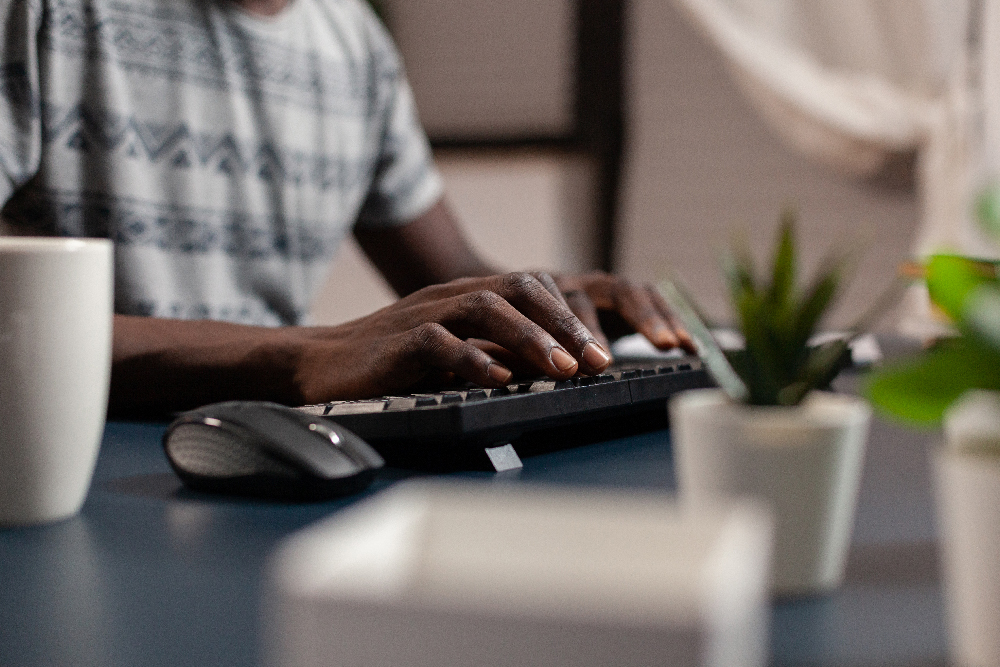 Closeup of african american working from his home business